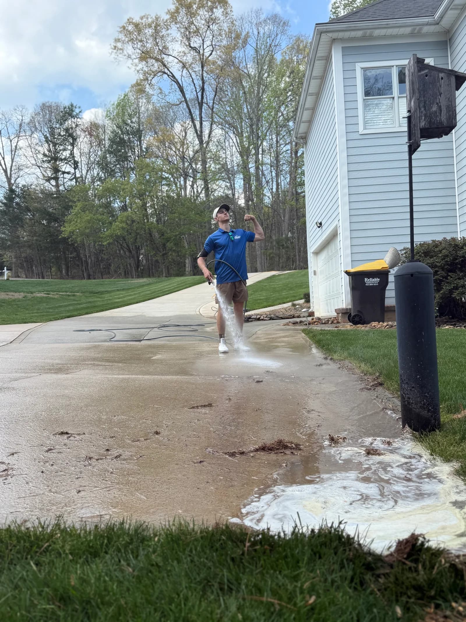 Ridge Curwood rinsing a clean concrete driveway in a Mooresville NC neighborhood