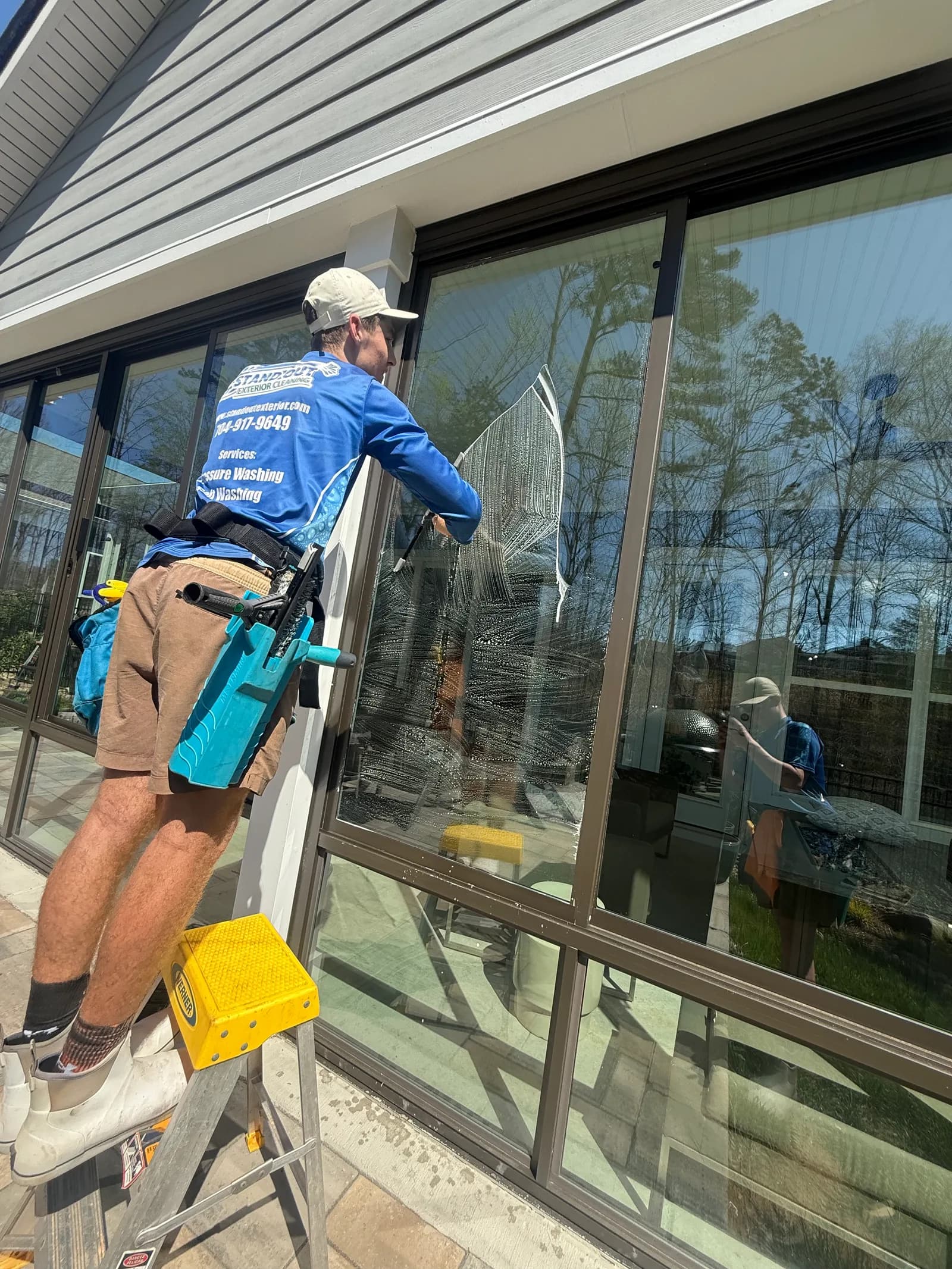 Ridge Curwood cleaning the exterior windows of a lakeside home in Denver NC