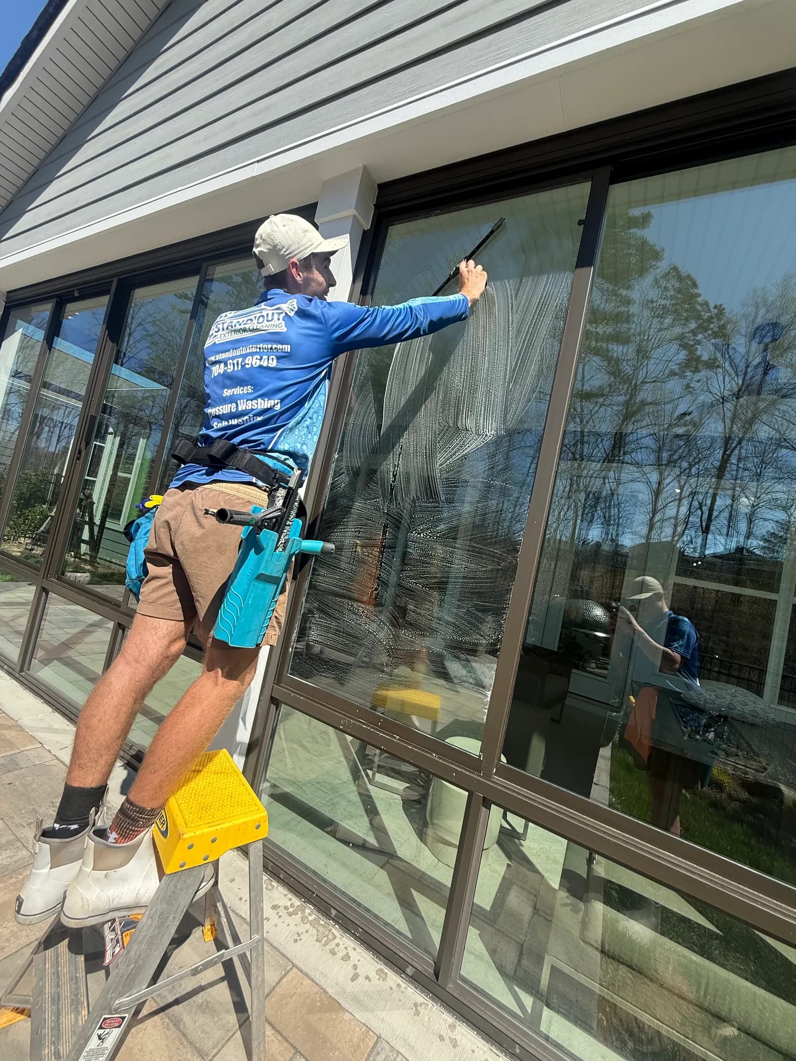 Ridge Curwood cleaning sunroom windows on a Cornelius NC home near Lake Norman